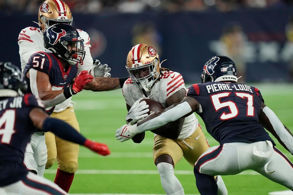 San Francisco 49ers running back Trey Sermon (28) runs against Houston Texans linebacker Kevin Pierre-Louis (57) during the first half of an NFL football game Thursday, Aug. 25, 2022, in Houston. (AP Photo/David J. Phillip)