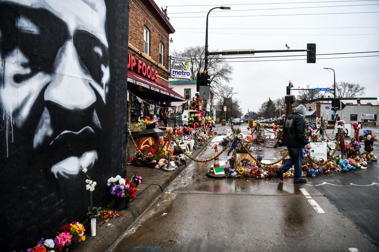 <p>A man walks near the makeshift memorial of George Floyd before the third day of jury selection begins in the trial of former Minneapolis Police officer Derek Chauvin who is accused of killing Floyd, in Minneapolis, Minnesota on March 10, 2021. </p> ((Photo by CHANDAN KHANNA / AFP))