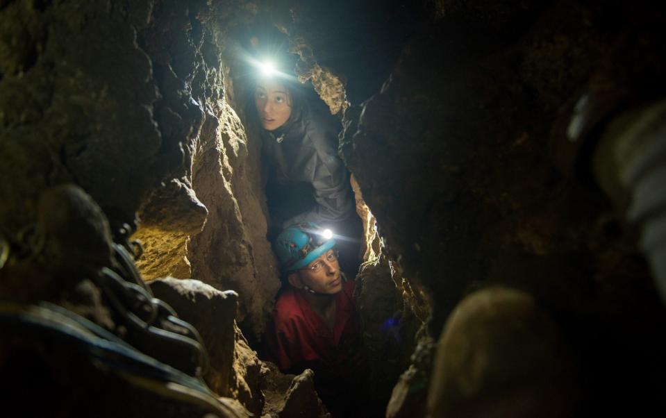 Lee Berger's daughter, Megan, and underground exploration team member Rick Hunter navigate the narrow chutes leading to the Dinaledi Chamber of the Rising Star cave in South Africa - National Geographic Image Collection 