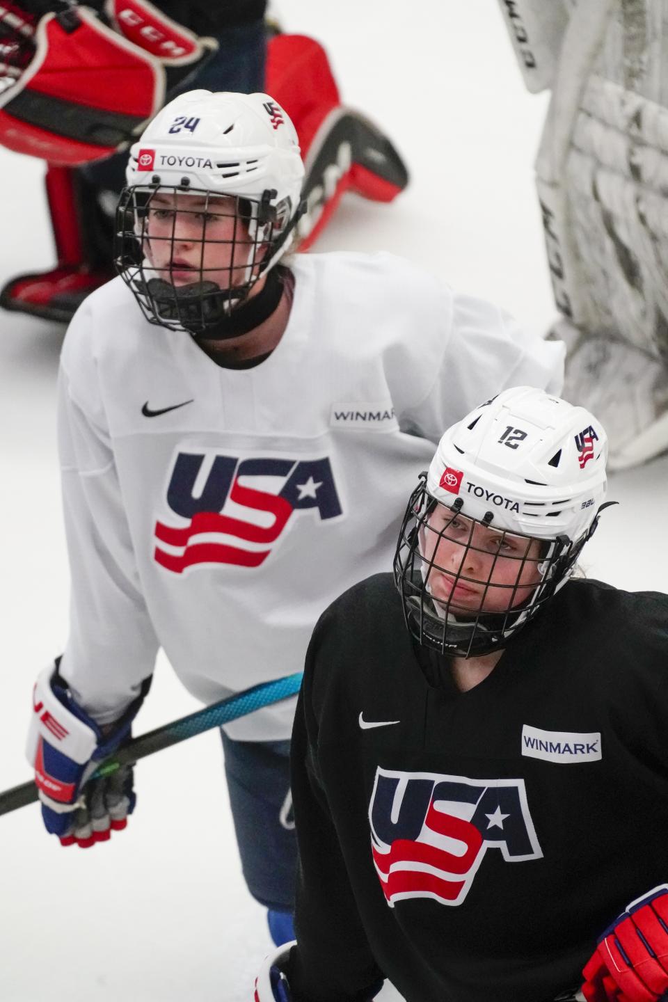 Sydney Morrow and Maggie Scannell listen to their coach as they practice for the 2022 U.S. U18 Women's World Hockey Championships Saturday, June 11, 2022, in Madison, Wis. Nearly one-third of the players on the U.S. women's hockey team competing in this week’s under-18 World Championships are training at programs outside their home states. (AP Photo/Morry Gash)