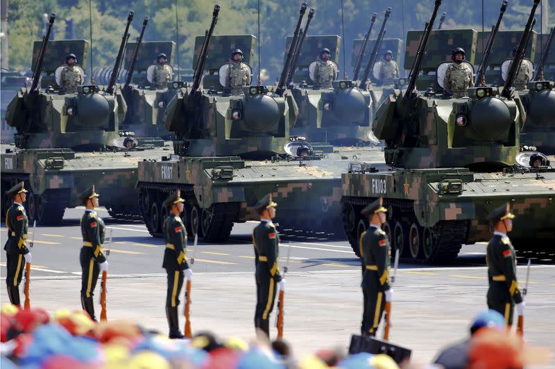 FILE PHOTO: China's People's Liberation Army (PLA) soldiers on their armoured vehicles equipped with anti-aircraft artillery roll to Tiananmen Square during the military parade marking the 70th anniversary of the end of World War Two, in Beijing