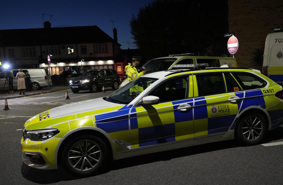 Police officers block a road near the Belfairs Methodist Church in Eastwood Road North, where British Conservative lawmaker David Amess died after being stabbed at a constituency surgery, in Leigh-on-Sea, Essex, England, Friday, Oct. 15, 2021. Police gave no immediate details on the motive for the killing of 69-year-old Conservative lawmaker Amess and did not identify the suspect, who was being held on suspicion of murder. (AP Photo/Kirsty Wigglesworth)