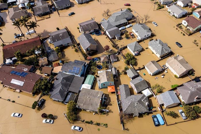 aerial view of a suburban neighborhood flooded with brown water