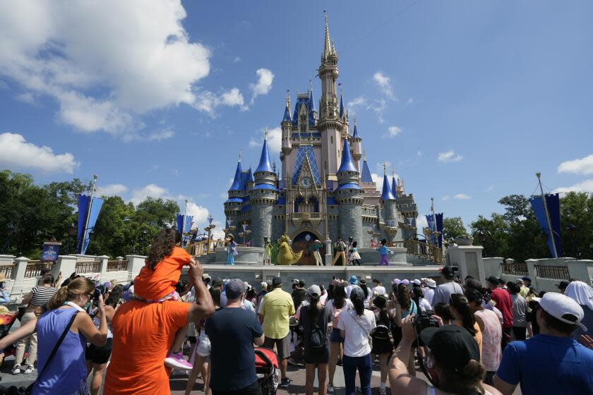 Park guests watch a musical show in front of the Cinderella Castle at the Magic Kingdom at Walt Disney World Friday, July 14, 2023, in Lake Buena Vista, Fla. (AP Photo/John Raoux)