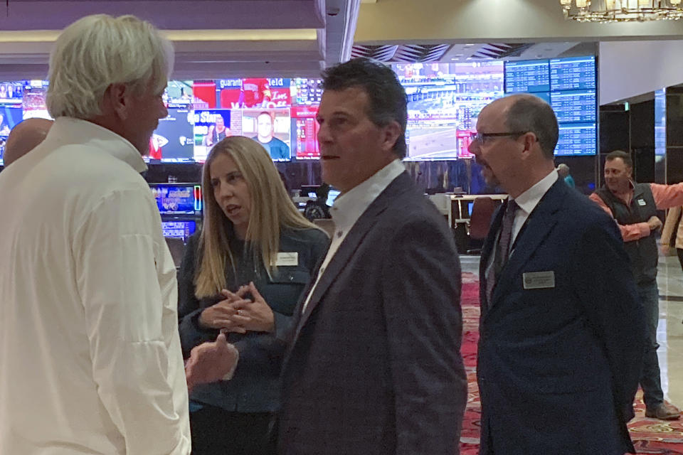 Nevada basketball coach Steve Alford, center, talks to wolf pack backers on the floor of the grand Sierra resort hotel casino ahead of a news conference Wednesday, Sept. 27, 2023 in Reno, Nev. The University of Nevada’s basketball team could have a new off-campus home by 2026 under an ambitious 10-year expansion plan that Reno’s largest hotel-casino announced Wednesday. The nearly $1 billion private capital investment will be the biggest in the city's history, according to officials of the Grand Sierra Resort. (AP Photo/Scott Sonner)