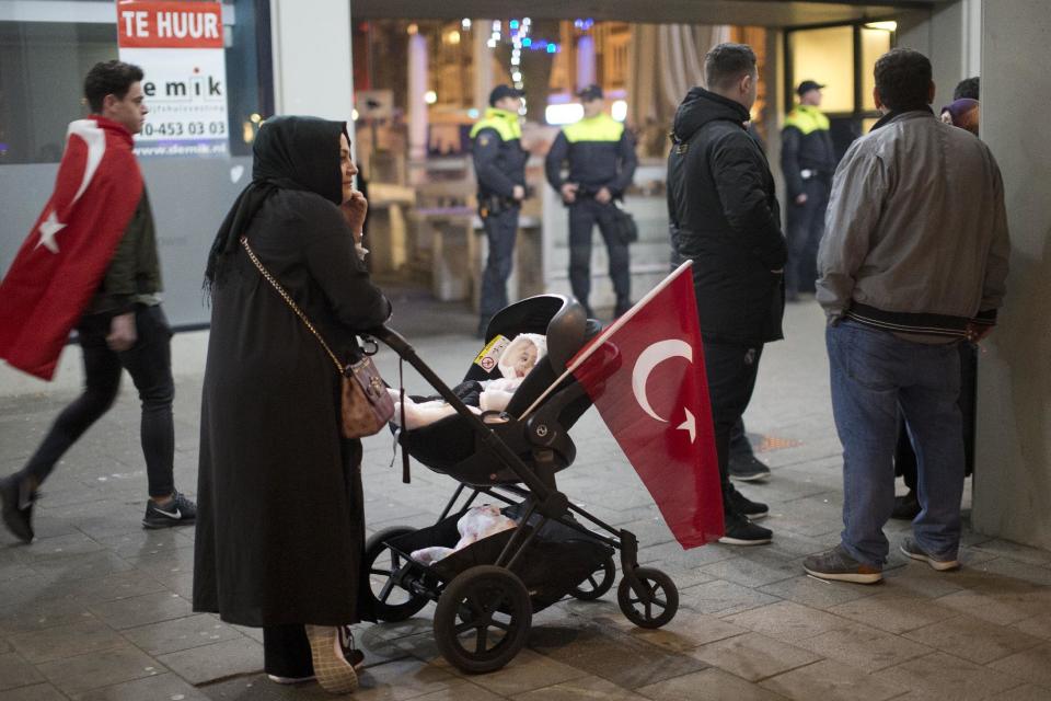 Demonstrators arrive at the Turkish consulate in Rotterdam, Netherlands, Saturday, March 11, 2017. Turkish Foreign Minister Mevlut Cavusoglu was due to visit Rotterdam on Saturday to campaign for a referendum next month on constitutional reforms in Turkey. The Dutch government says that it withdrew the permission for Cavusoglu's plane to land because of "risks to public order and security." (AP Photo/Peter Dejong)