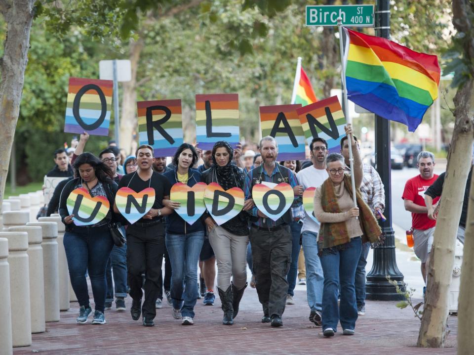 <p>Several hundred supporters, led by Laura Kanter, right, marched to Sasscer Park after a vigil at Calle Cuatro Plaza in support of the Orlando shooting victims, June 12, 2016, in Santa Ana, Calif. (Kevin Sullivan/The Orange County Register via AP) </p>