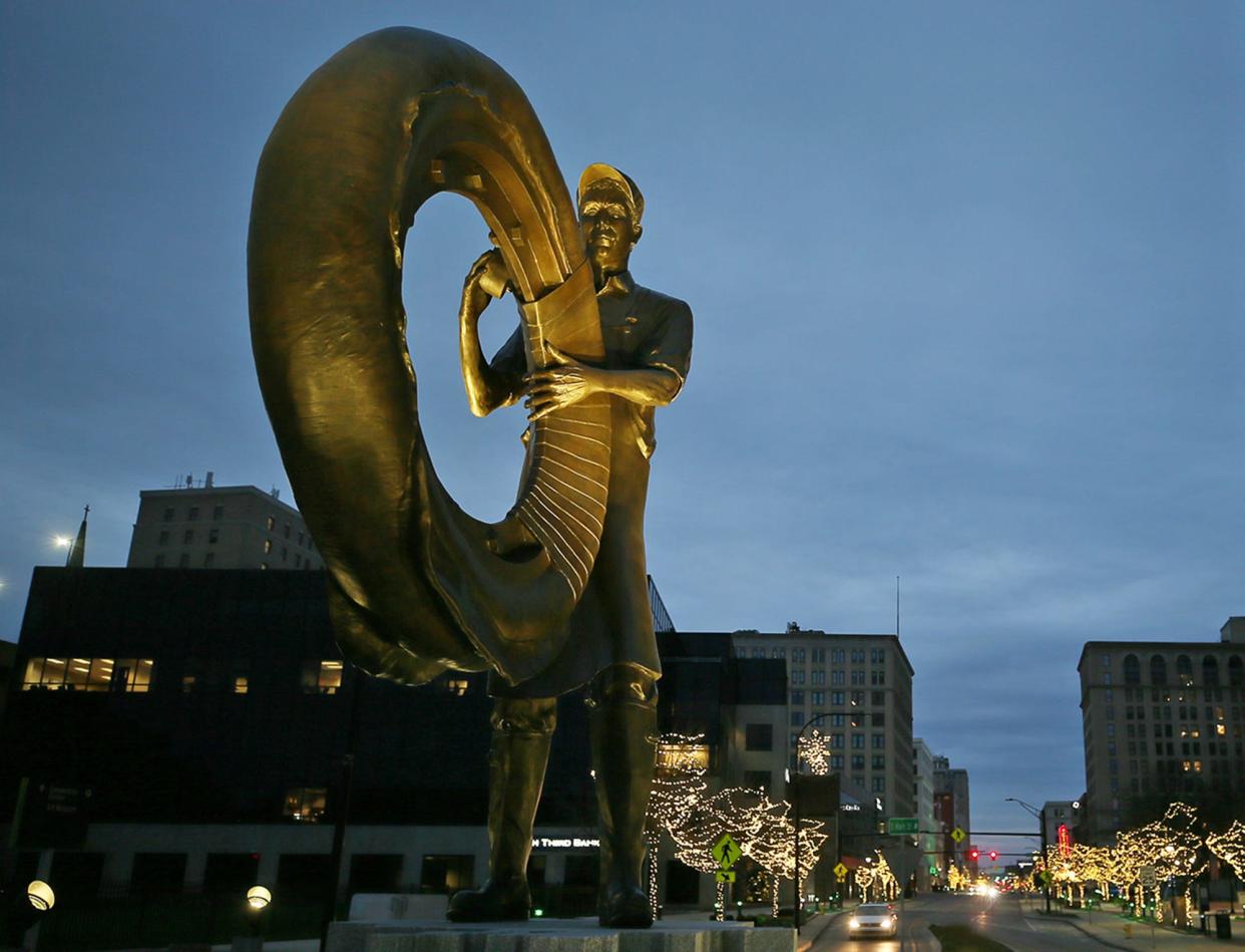 The iconic rubber worker statue is seen in the pre-dawn light in downtown Akron. Could the city be the rubber capital of the world again?