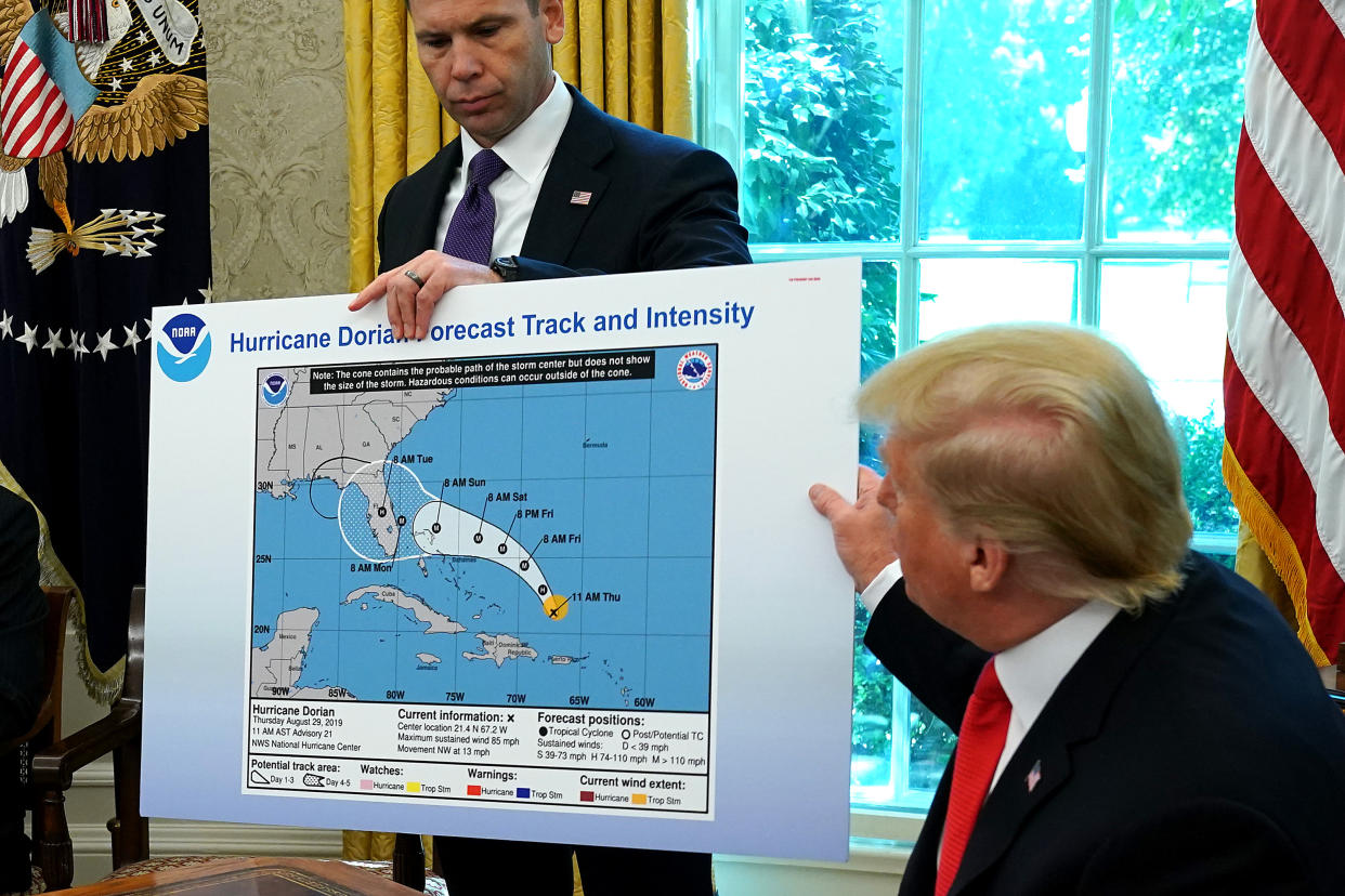 President Trump references a map held by acting Homeland Security Secretary Kevin McAleenan while talking to reporters following a briefing from officials about Hurricane Dorian. (Photo: Chip Somodevilla/Getty Images)