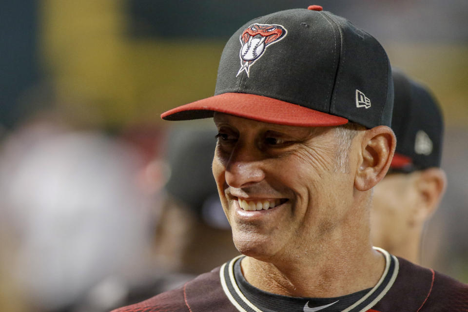 Arizona Diamondbacks manager Torey Lovullo laughs in his dugout as his team battles against the San Diego Padres during the first inning of a baseball game Sunday, Sept. 29, 2019, in Phoenix. (AP Photo/Darryl Webb)