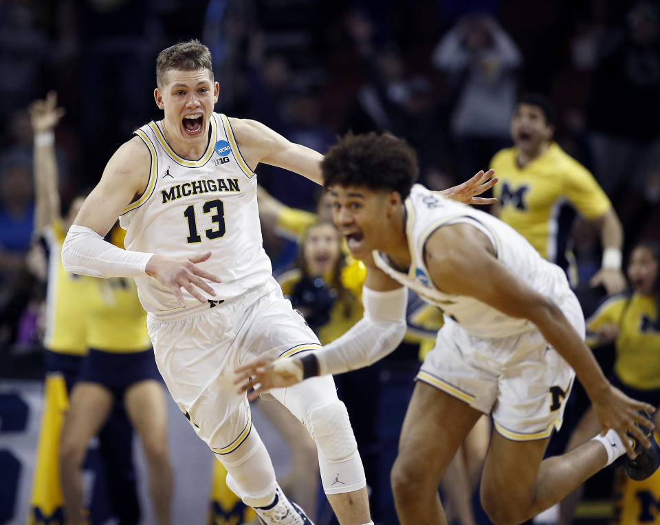 Michigan guard Jordan Poole (2) is chased by forward Moritz Wagner (13) after his 3-pointer to beat Houston last weekend (AP)