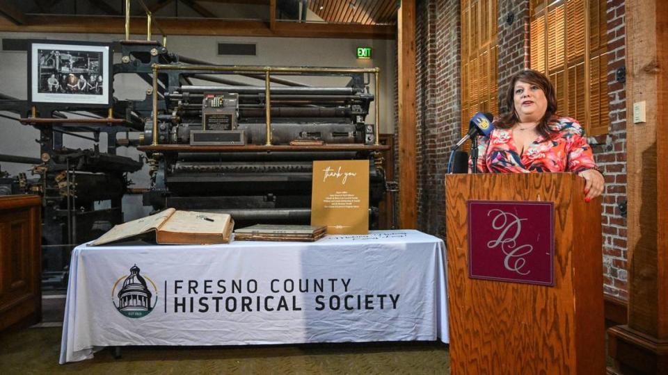 Elizabeth Laval, president of the Fresno County Historical Society, stands in front of the old Fresno Republican newspaper press while announcing the purchase of the Fresno Republican Printery building on Kern near L Street in downtown Fresno by the historical society on Thursday, Oct. 5, 2023.
