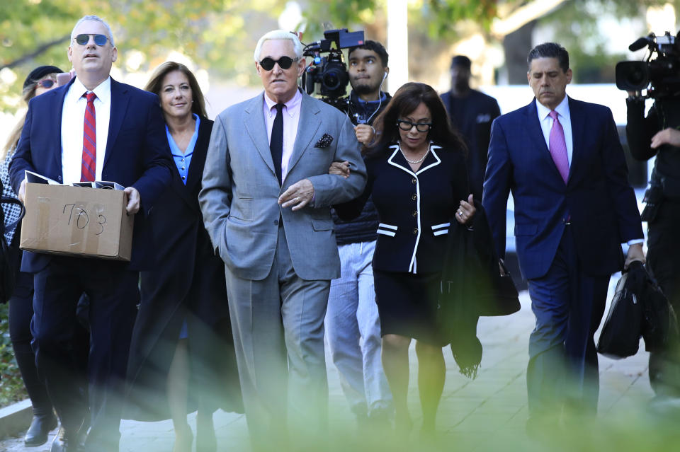 Roger Stone, center, with his wife, Nydia Stone, second from right, arrive at the federal court in Washington, Tuesday, Nov. 5, 2019. Stone, a longtime Republican provocateur and former confidant of President Donald Trump, goes on trial over charges related to his alleged efforts to exploit the Russian-hacked Hillary Clinton emails for political gain. (AP Photo/Manuel Balce Ceneta)