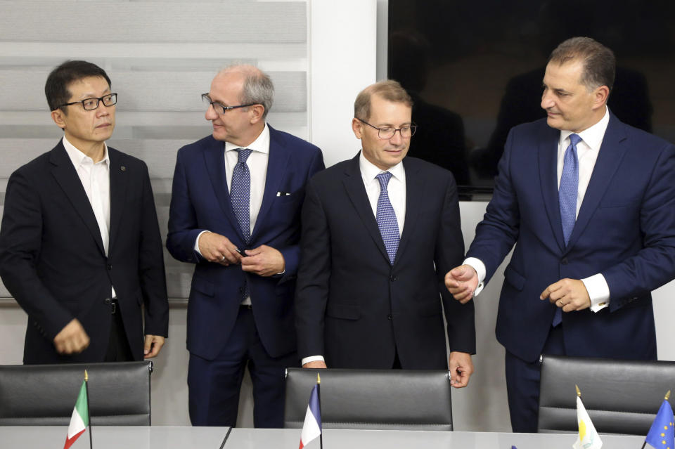 Cyprus' Energy Minister Georgios Lakkotrypis, right, General Manager of Total in Cyprus Yves Grosjean, second right, Manager director of ENI Cyprus Allesandro Barberis, second left, and Director of Kongas Cyprus Insu Woo after signing a deal at the Energy ministry in Nicosia, Cyprus, Wednesday, Sept. 18, 2019. Cyprus' energy minister says a consortium made up of energy companies Total of France and Eni of Italy has been granted a license to explore for natural gas deposits in another area off Cyprus' southern coast. (AP Photo/Petros Karadjias)