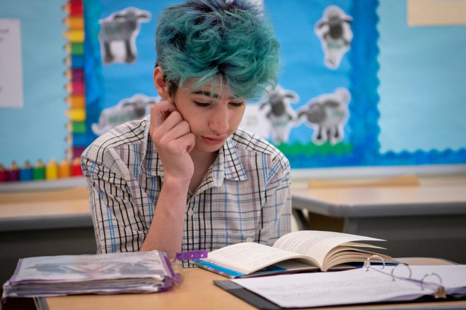 Isaac Rosenthal reads along as one of his classmates reads aloud a passage from a schoolbook.