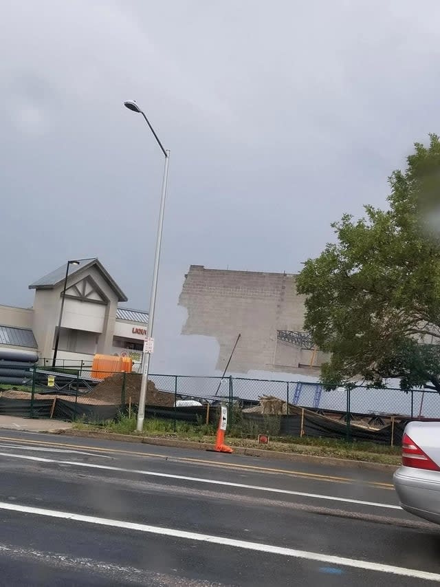 side of a brick building seems to be painted the same color as the sky