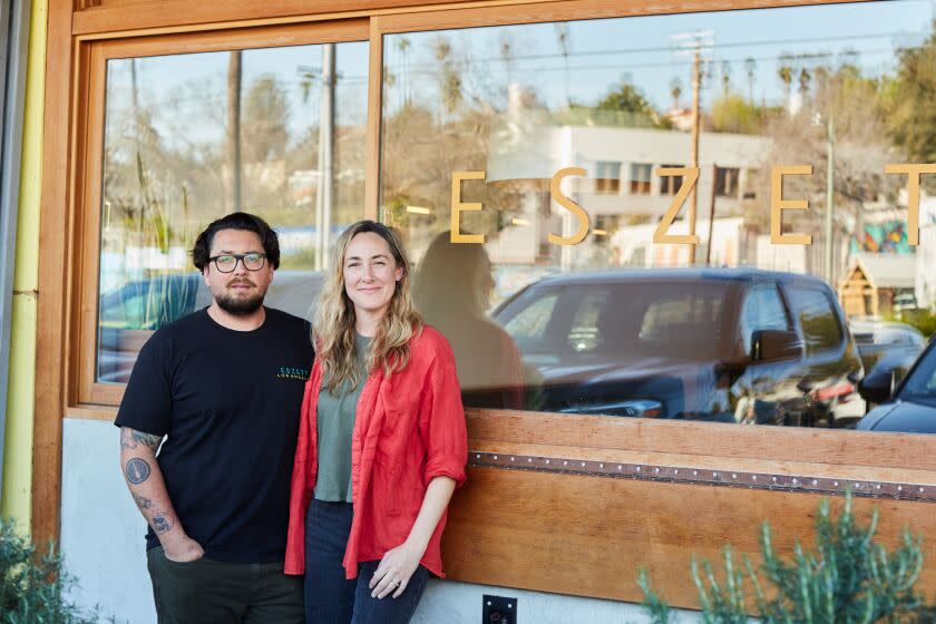 LOS ANGELES, CA - JANUARY 27, 2023: Huband and wife duo, Spencer and Sabrina Bezaire, pose for photographs outside of their restaurant, Eszette.