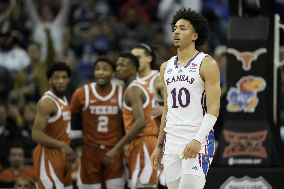 Kansas forward Jalen Wilson (10) walks to the bench for a timeout during the first half of the NCAA college basketball championship game against Texas in the Big 12 Conference tournament Saturday, March 11, 2023, in Kansas City, Mo. (AP Photo/Charlie Riedel)