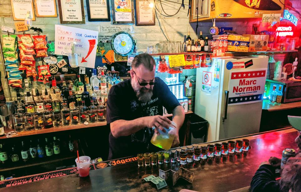 Chuck Marthaler tends bar at the Palo Verde Lounge in Tempe, Arizona.