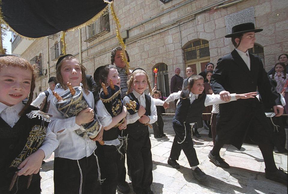 <span class="caption">Ultra Orthodox children march with Torah scrolls in Jerusalem’s Mea Shearim neighborhood during Shavuot celebrations.</span> <span class="attribution"><a class="link " href="https://www.gettyimages.com/detail/news-photo/ultra-orthodox-children-march-with-torah-scrolls-at-mea-news-photo/71088873?adppopup=true" rel="nofollow noopener" target="_blank" data-ylk="slk:Menahem Kahana/AFP via Getty Images;elm:context_link;itc:0;sec:content-canvas">Menahem Kahana/AFP via Getty Images</a></span>