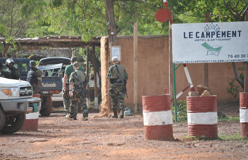 <p>Malian and European forces walk at the entrance of the Kangaba tourist resort on the edge of Bamako on June 19, 2017, a day after suspected jihadists stormed the resort, briefly seizing more than 30 hostages and leaving at least two people dead. (Habibou Kouyate/AFP/Getty Images) </p>
