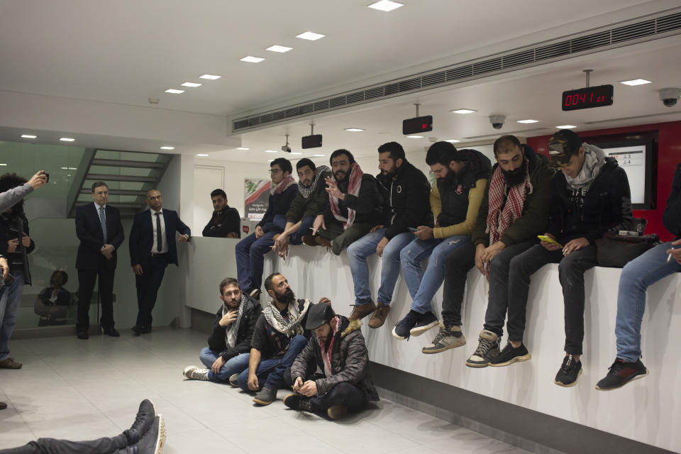 Anti-government protesters occupy the Hamra branch of BLC Bank Dec. 28, 2019 in Beirut, Lebanon. Banks have imposed weekly limits on withdrawals of U.S. dollars amid a shortage in liquidity and as the country grapples with its worst economic and financial crisis since the end of the 1975-90 civil war. The country has been without a prime minister since ongoing mass protests forced the resignation of Premier Saad Hariri on Oct. 29. (AP Photo/Maya Alleruzzo)