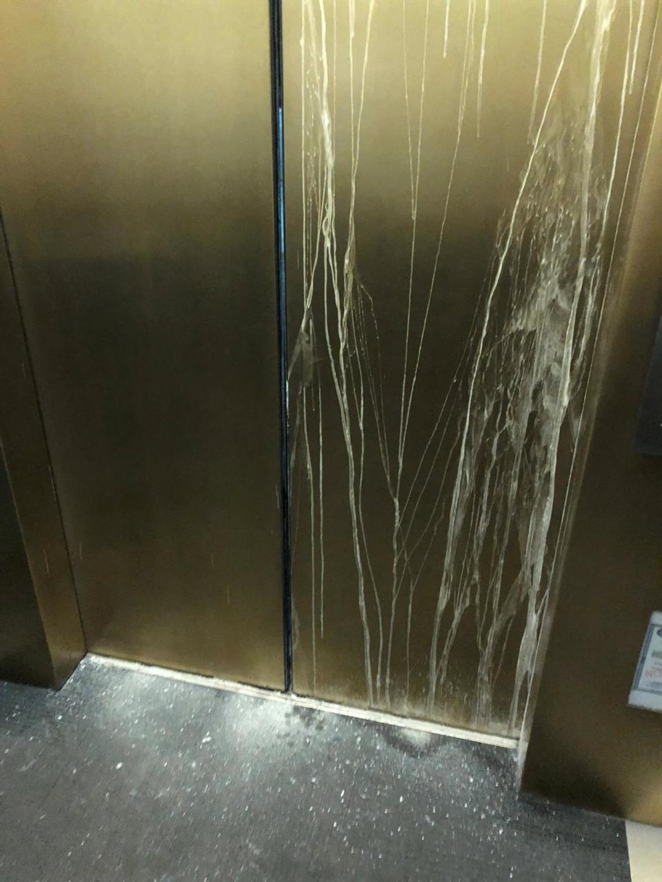 Cracked door of an elevator with six people trapped inside is pictured as the rescue crew try to open it (REUTERS)