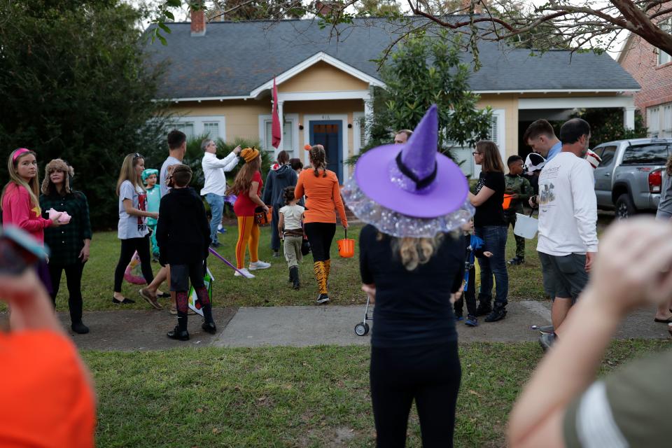 Crowds gather in front of houses during trick or treating in the area near Beard Street in Tallahassee, Fla. Wednesday, Oct. 31, 2018. 
