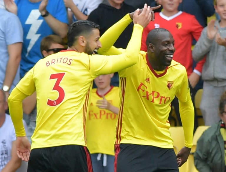 Watford's Stefano Okaka (R) celebrates scoring the opening goal during their English Premier League match against Liverpool, at Vicarage Road Stadium in Watford, on August 12, 2017