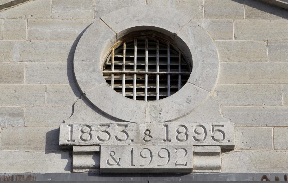 A view of a stone plaque at Kingston Penitentiary in Kingston, Ontario October 11, 2013. British North America's first penitentiary, the "Kingston Pen" as it is known, is now closed. Situated on prime real estate on the shore of Lake Ontario, its fate is unknown despite being designated as a National Historic Site. Public tours are currently being held to raise money for the United Way. The prison was once home to Canada's most famous criminals including Canadian serial killers Clifford Olson and Paul Bernardo. REUTERS/Fred Thornhill (CANADA - Tags: CRIME LAW SOCIETY)