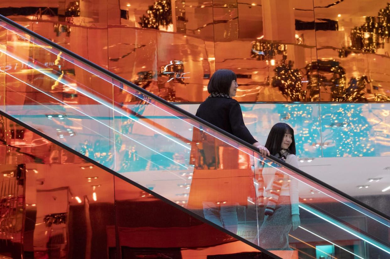 Customers ride escalators designed by Dutch architect Rem Koolhaas at the Saks Fifth Avenue Flagship in New York in 2019. (AP Photo/Mary Altaffer)