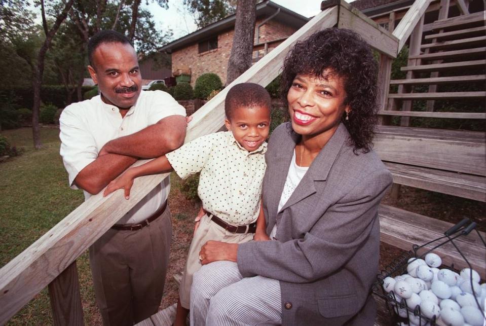 The Wilson family: Miles Wilson II, left, their son Miles Wilson III and Rosa Carrera-Wilson pose in their backyard in the Woodhaven neighborhood of Fort Worth. Their backyard borders the Woodhaven Country Club golf course and one of Miles II favorite thing to do is look for golf balls in his backyard.