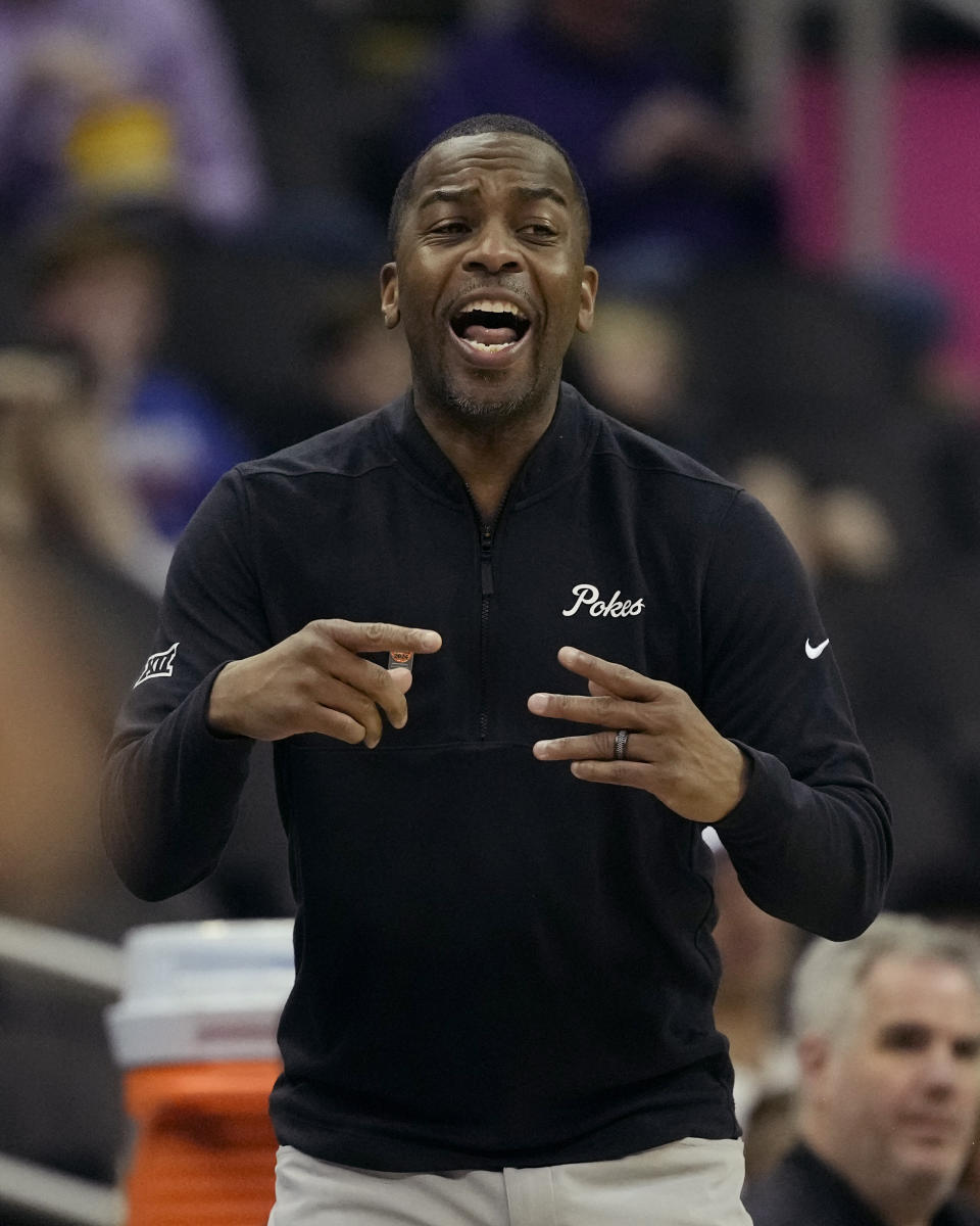 Oklahoma State head coach Mike Boynton, Jr. talks to his players during the first half of an NCAA college basketball game against UCF Tuesday, March 12, 2024, in Kansas City, Mo. (AP Photo/Charlie Riedel)