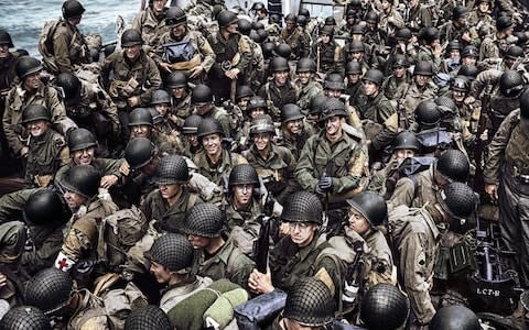 US Army troops shown in a colourised photograph of the D-Day invasion - Credit: US Navy/Getty