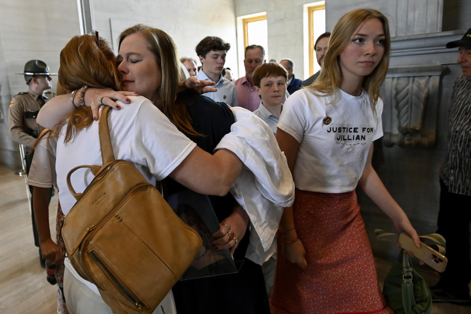 Jessica Ludwig receives a hug from Shelley Mechalovich, right, after a bill passed in the House that would involuntarily commit certain criminal defendants for inpatient treatment and also temporarily remove their gun rights if they are ruled incompetent to stand trial due to intellectual disability or mental illness, Monday, April 15, 2024, in Nashville, Tenn. The bill is named for Jillian Ludwig, a Belmont University student killed last year by a stray bullet shot allegedly by a man the court had previously declared mentally incompetent. (AP Photo/Mark Zaleski)