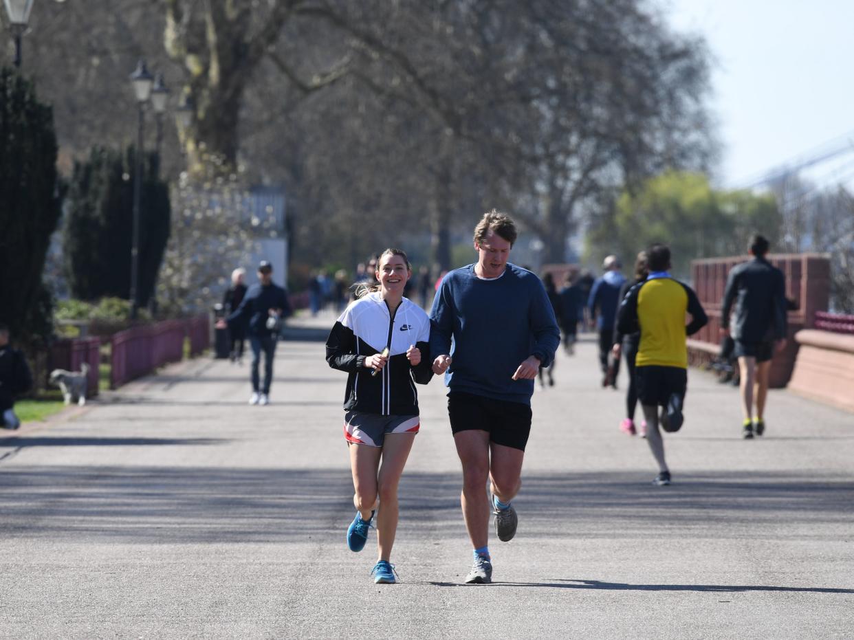 Joggers run through Battersea Park, London (Stefan Rousseau/PA)