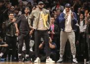 Apr 10, 2019; Brooklyn, NY, USA; NBA stars Chris Paul (left) LeBron James (center) and Carmelo Anthony cheering on Miami Heat guard Dwyane Wade against the Brooklyn Nets in the third quarter at Barclays Center. This is reportedly the final game of Dwyane Wade's NBA career. Mandatory Credit: Wendell Cruz-USA TODAY Sports