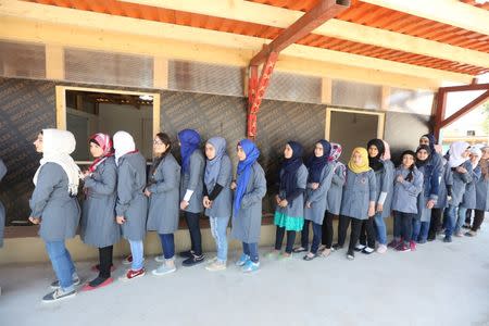 Syrian refugee girls stand in line at a school for Syrian refugee girls, built by the Lebanese non-profit Kayany Foundation in Bar Elias town, in the Bekaa valley, Lebanon October 19, 2017. Picture taken October 19, 2017. REUTERS/Aziz Taher