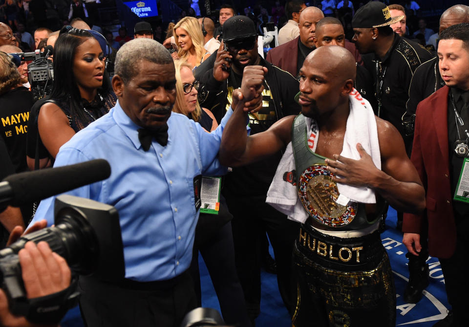 LAS VEGAS, NV - AUGUST 26:  Referee Robert Byrd raises the hand of Floyd Mayweather Jr. after his TKO of Conor McGregor in their super welterweight boxing match on August 26, 2017 at T-Mobile Arena in Las Vegas, Nevada.  (Photo by Josh Hedges/Zuffa LLC/Zuffa LLC via Getty Images )