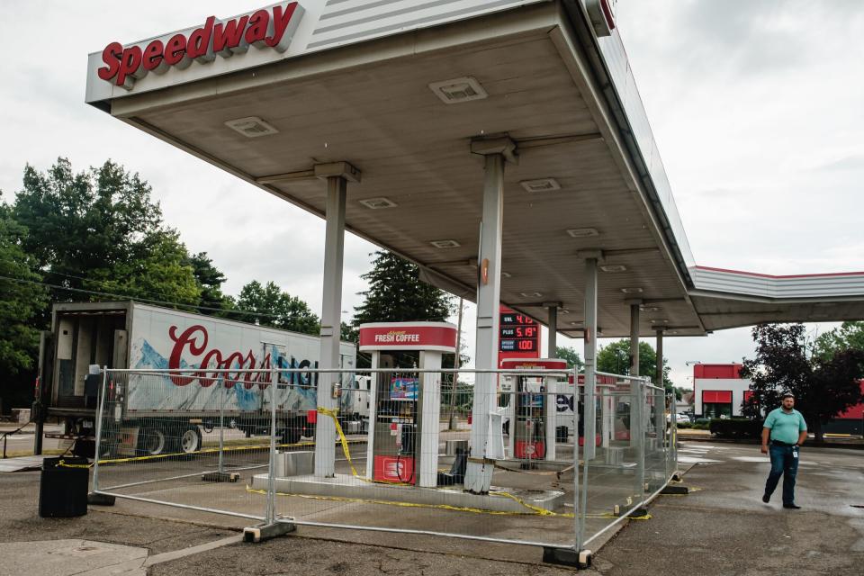 A Speedway maintenance worker surveys damage done to the overhang stanchion at the Speedway gas station at 1042 N Tuscarawas Ave. in Dover on Tuesday.