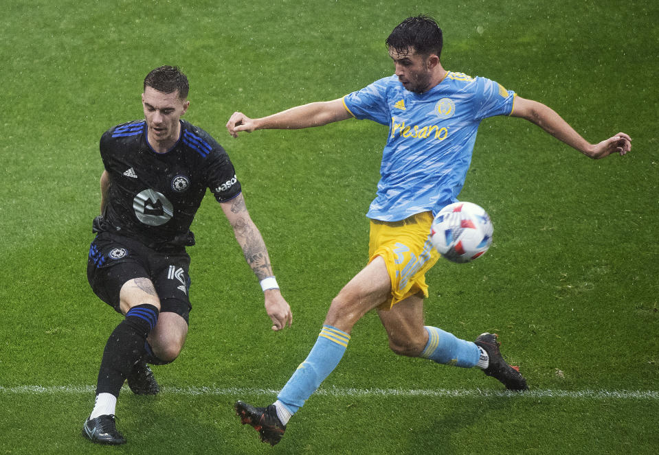 CF Montreal's Joel Waterman, left, clears the ball as Philadelphia Union's Leon Flach moves in during the second half of an MLS soccer game, Saturday, Oct. 16, 2021, in Montreal. (Graham Hughes/The Canadian Press via AP)