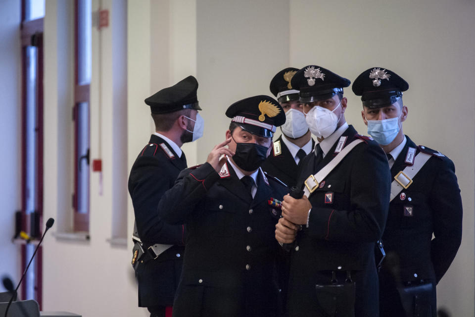 Carabinieri police officers wear face masks to curb the spread of COVID-19 as they stand inside a specially constructed bunker hosting the first hearing of a maxi-trial against more than 300 defendants of the ‘ndrangheta crime syndicate, near the Calabrian town of Lamezia Terme, southern Italy, Wednesday, Jan. 13, 2021. A maxi-trial opened Wednesday in southern Italy against the ‘ndrangheta crime syndicate, arguably the world's richest criminal organization that quietly amassed power in Italy as the Sicilian Mafia lost its influence. (Valeria Ferraro/LaPresse via AP)