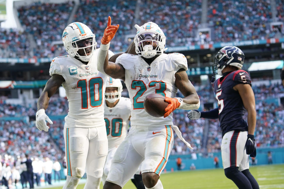 Miami Dolphins running back Jeff Wilson Jr. (23) celebrates his touchdown during the first half of an NFL football game against the Houston Texans, Sunday, Nov. 27, 2022, in Miami Gardens, Fla. (AP Photo/Lynne Sladky)