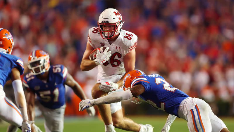 Utah Utes tight end Dalton Kincaid tries to avoid Florida safety Rashad Torrence II (22) in Gainesvillle, Fla., on Saturday, Sept. 3, 2022. Thursday night, Kincaid was selected in the first round of the NFL draft by the Buffalo Bills.