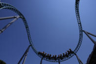 Visitors enjoy a ride on a roller coaster at Cinecitta World amusement park in the outskirts of Rome in the day of its reopening, Thursday, June 17, 2021. Amusement parks have been closed since Oct. 25 2020, when Italy's second national lockdown started. (AP Photo/Alessandra Tarantino)