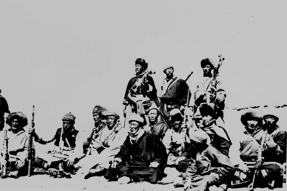 FILE - In this March 1959, file photo, the Dalai Lama, sitting center, rests with warriors who protected him in the Himalayas after fleeing the sacred capital Lhasa. Despite pursuit and road blocks, the Dalai Lama reached the free zone of India on March 31. (AP Photo, File)