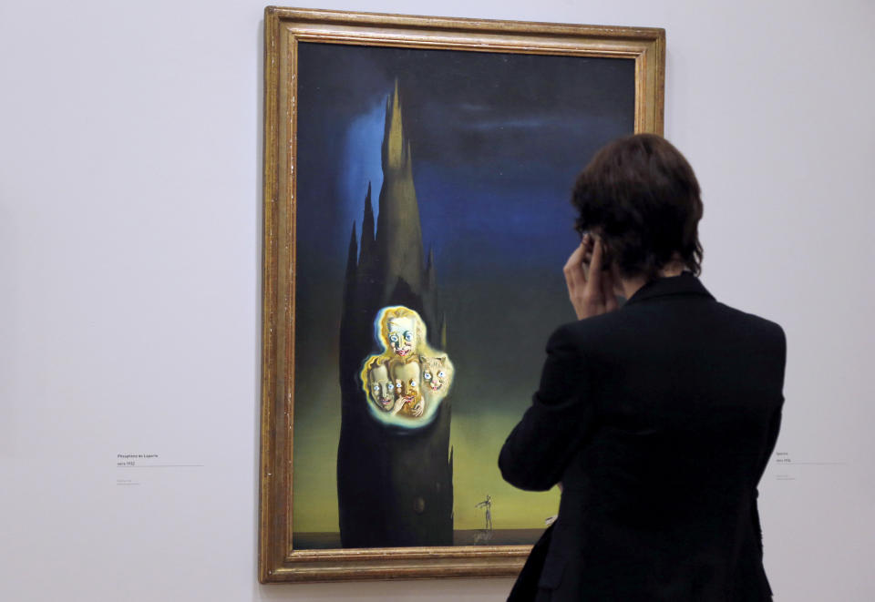 A visitor looks at a painting entitled 'Phosphene de Laporte' by Spanish surrealist artist Salvador Dali during an exhibition devoted to his work at the Centre Pompidou contemporary art center (aka Beaubourg) on November 19, 2012 in Paris. More than 30 years after the first retrospective in 1979, the event gathers more than 200 art pieces and runs until March 13, 2013. (FRANCOIS GUILLOT/AFP/Getty Images)