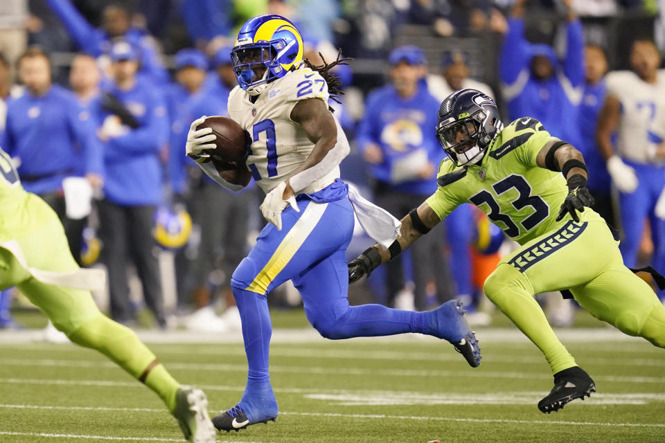 Los Angeles Rams running back Darrell Henderson (27) runs the ball as Seattle Seahawks safety Jamal Adams (33) pursues during the second half of an NFL football game, Thursday, Oct. 7, 2021, in Seattle. (AP Photo/Elaine Thompson)