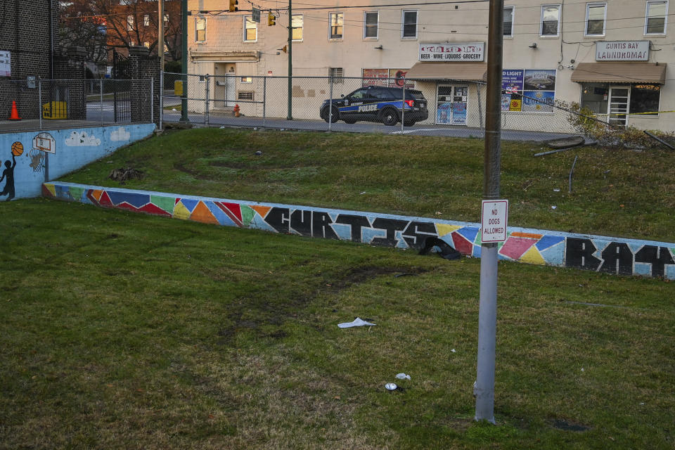 FILE - Car parts and damaged turf are seen in Curtis Bay Park following the shooting of a Baltimore Police officer early Thursday, Dec. 16, 2021. Trial began Tuesday, Feb. 27, 2024, for a man accused in the deadly shooting ambush of Baltimore police officer Keona Holley who was sitting in her patrol car when she was killed in 2021. (Jerry Jackson/The Baltimore Sun via AP, File)