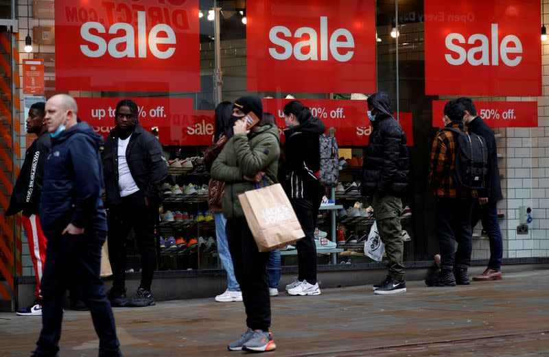 FILE PHOTO: Shoppers queue to enter a shoe shop at the start of the Boxing Day sales amid the outbreak of the coronavirus disease (COVID-19) in Manchester